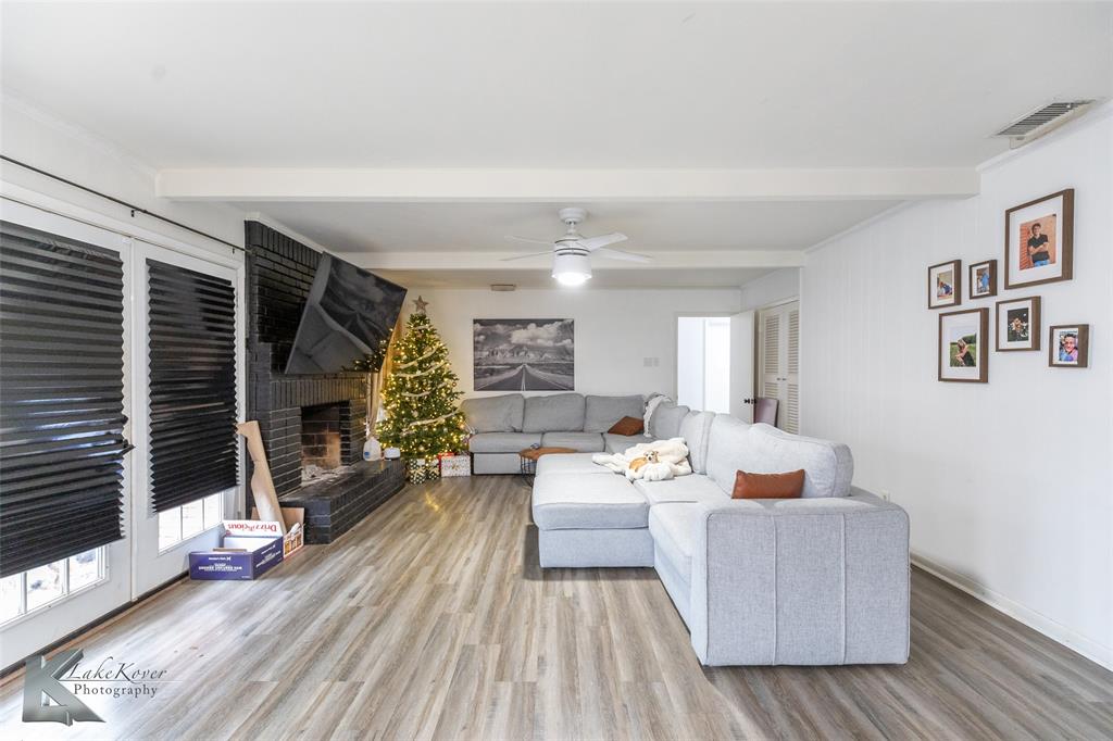 1909 River Oaks Road Abilene, TX 79605 - Photo 14 of 40 a living room with furniture and a fireplace