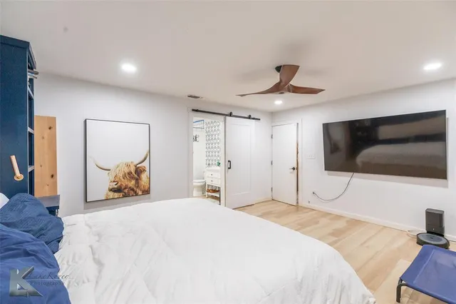 a bathroom with a sink mirror and toilet