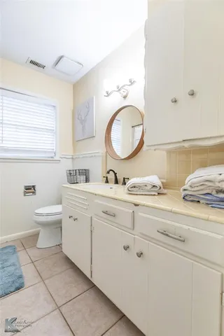 a spacious bedroom with a bed and a window