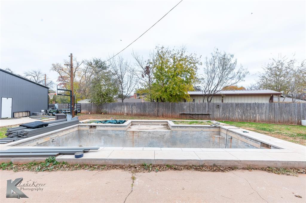 1909 River Oaks Road Abilene, TX 79605 - Photo 33 of 40 a view of a backyard with a tub and trees in the background