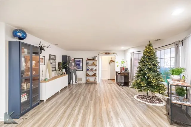 a large living room with a hard wood floor