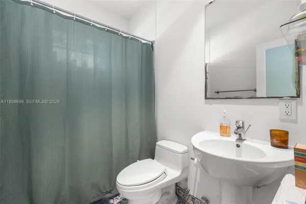 a white toilet sitting next to a bathroom sink