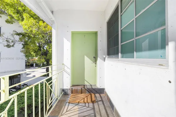 a view of balcony with wooden floor