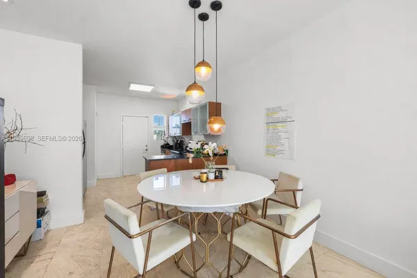 a view of a dining room with furniture and chandelier