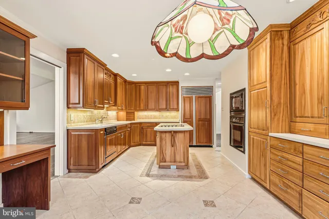a kitchen that has a sink and a stove in it