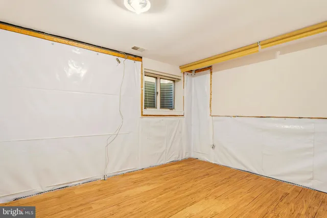 a view of an house with wooden floor and a large window