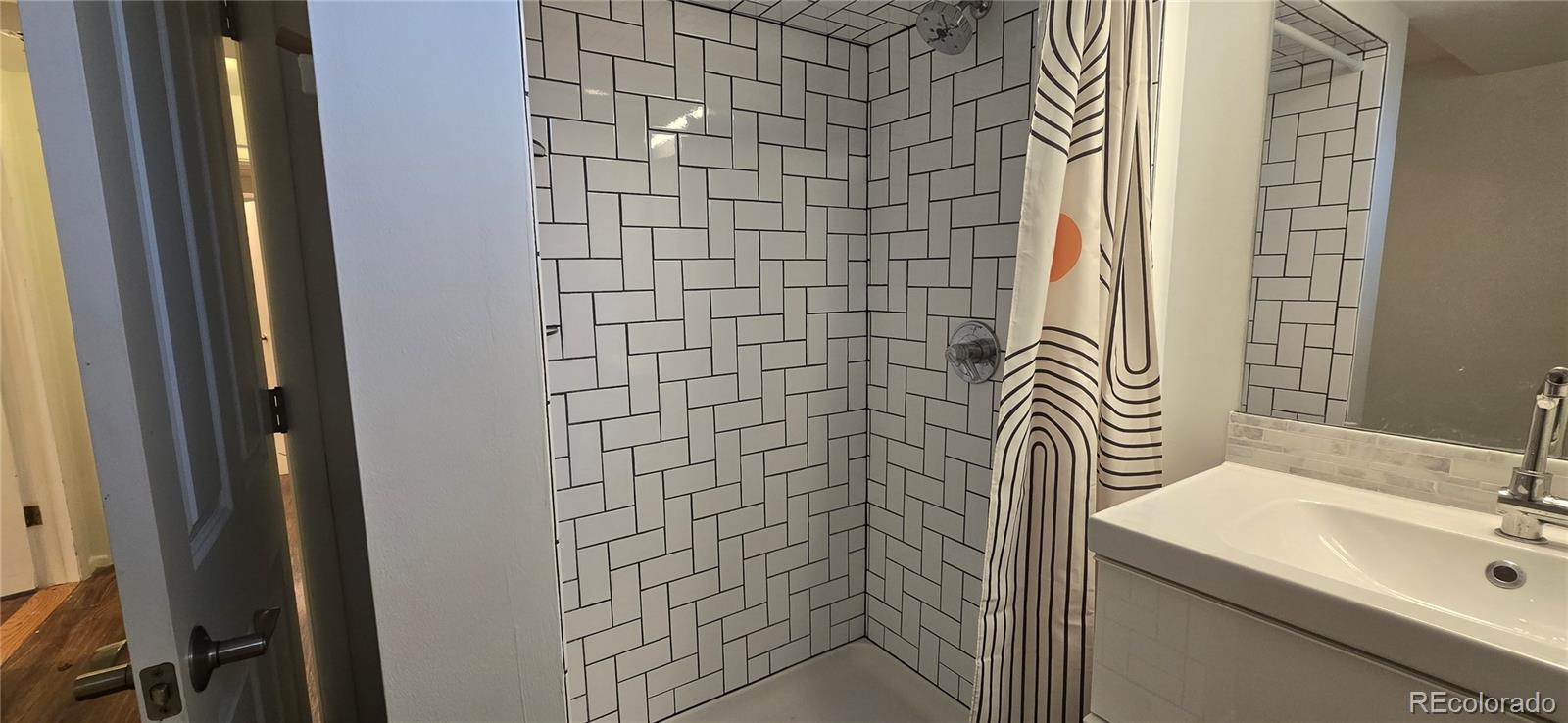 2940 19th Street Boulder, CO 80304 - Photo 7 of 10 a bathroom with a sink a toilet and shower