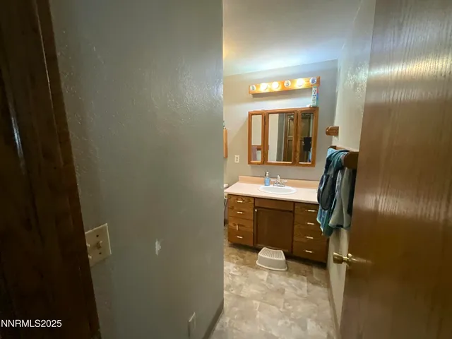 a bathroom with a sink a vanity and mirror