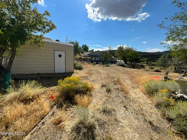 a view of a backyard of the house