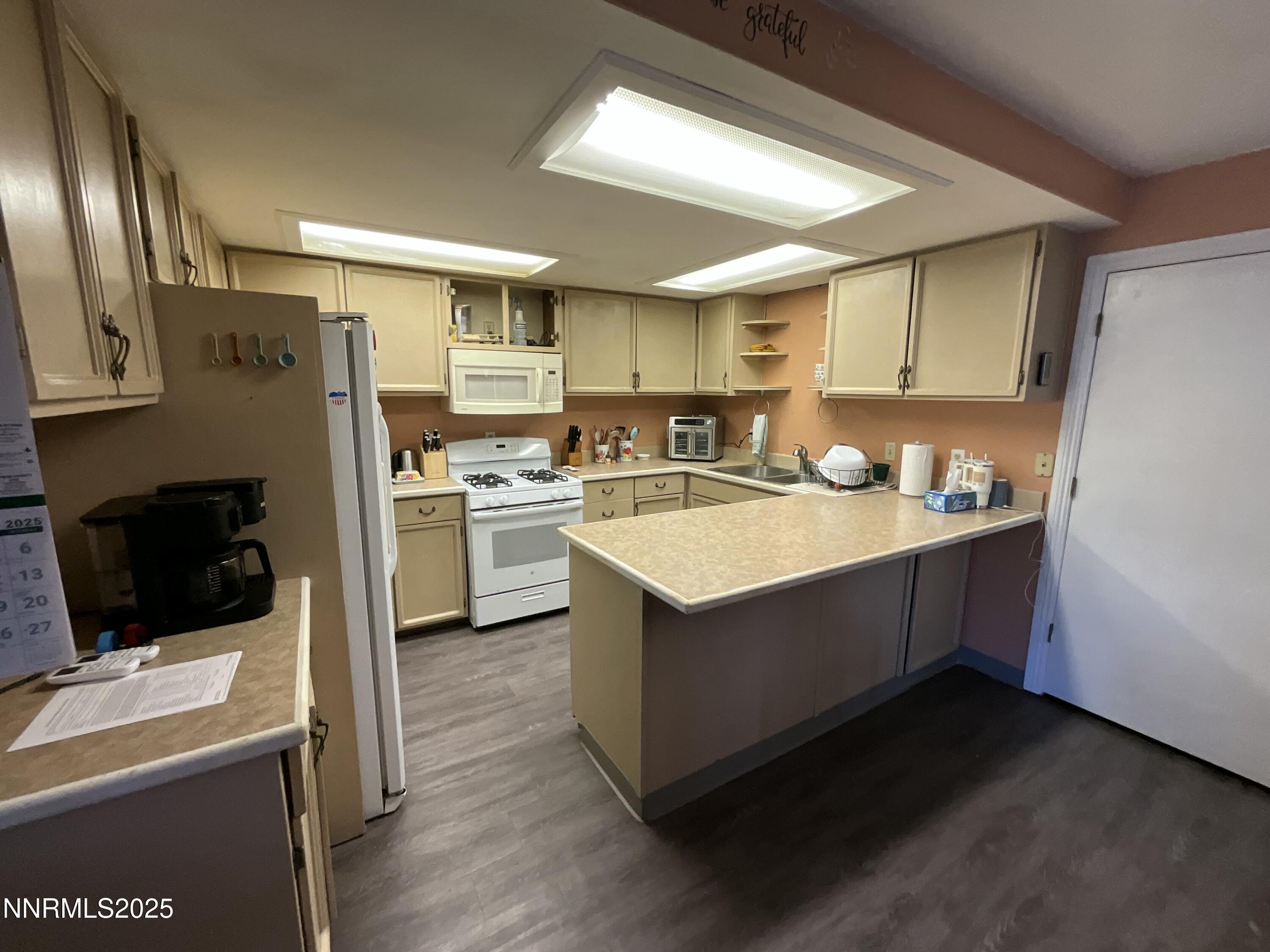 151 Bateman Street Austin, NV 89310 - Photo 4 of 33 a kitchen with a sink refrigerator and microwave