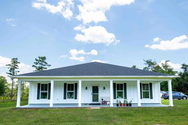 a view of a house with a swimming pool and a garden