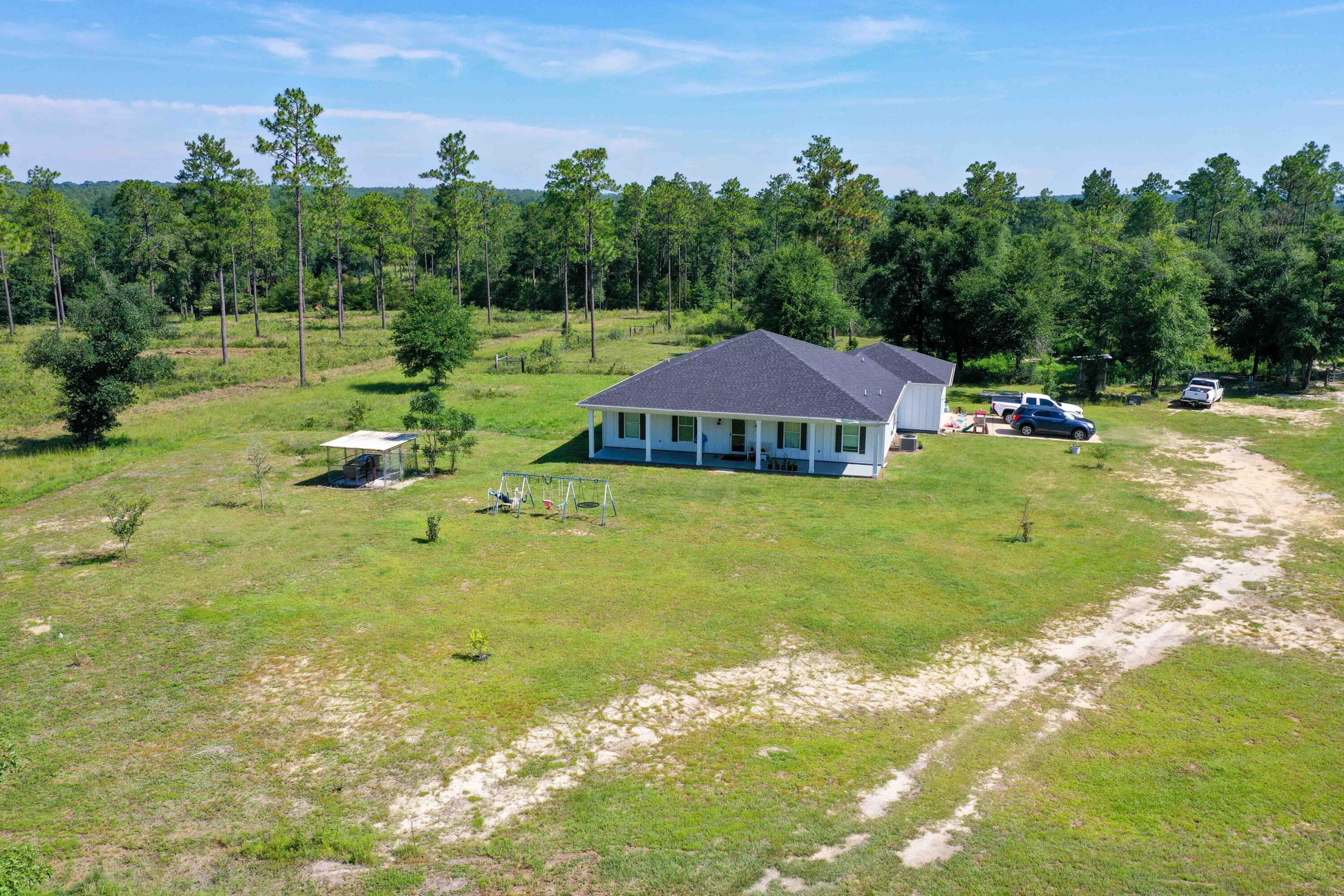 6251 Highway 4 Baker, FL 32531 - Photo 15 of 22 a view of a house with garden and trees