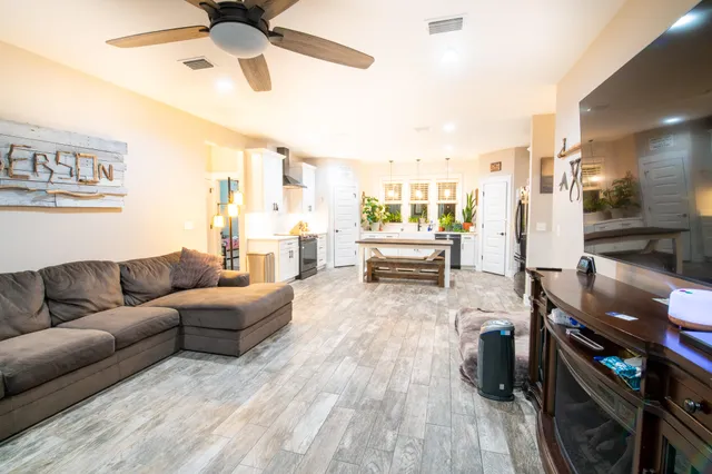 a living room with furniture and wooden floor