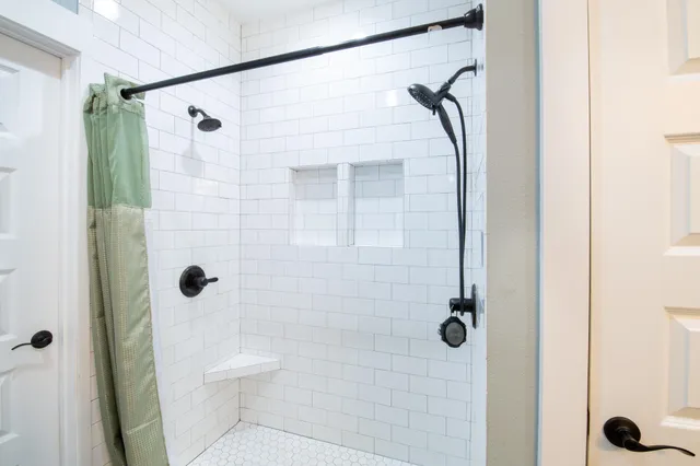 a bathroom with a shower and a toilet