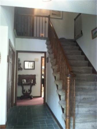 19 Randall Road Rochester, MA 02770 - Photo 5 of 19 a view of a hallway with wooden floor and staircase