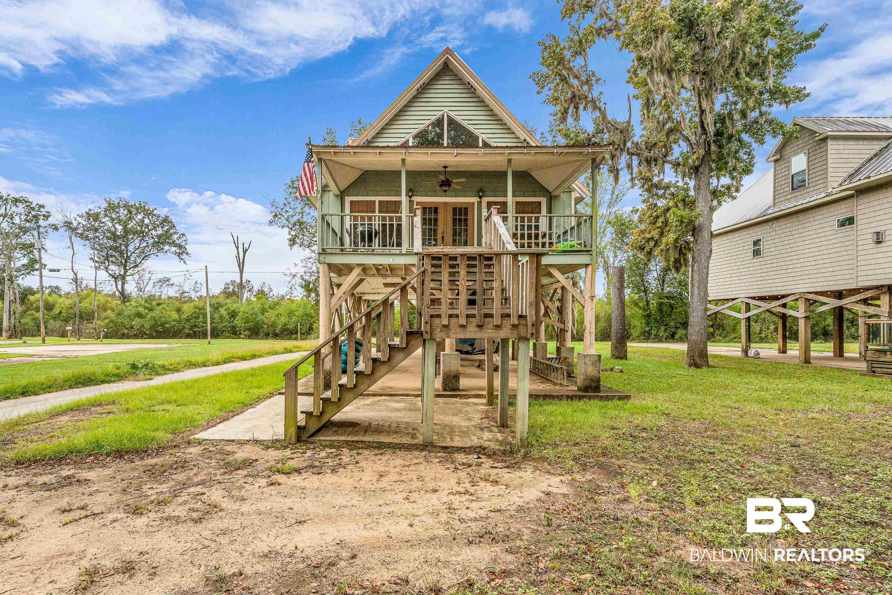 8317 Bryant's Lndg Road Stockton, AL 36579 - Photo 9 of 28 Rear view of house with a lawn, a ceiling fan, stairway, and a porch