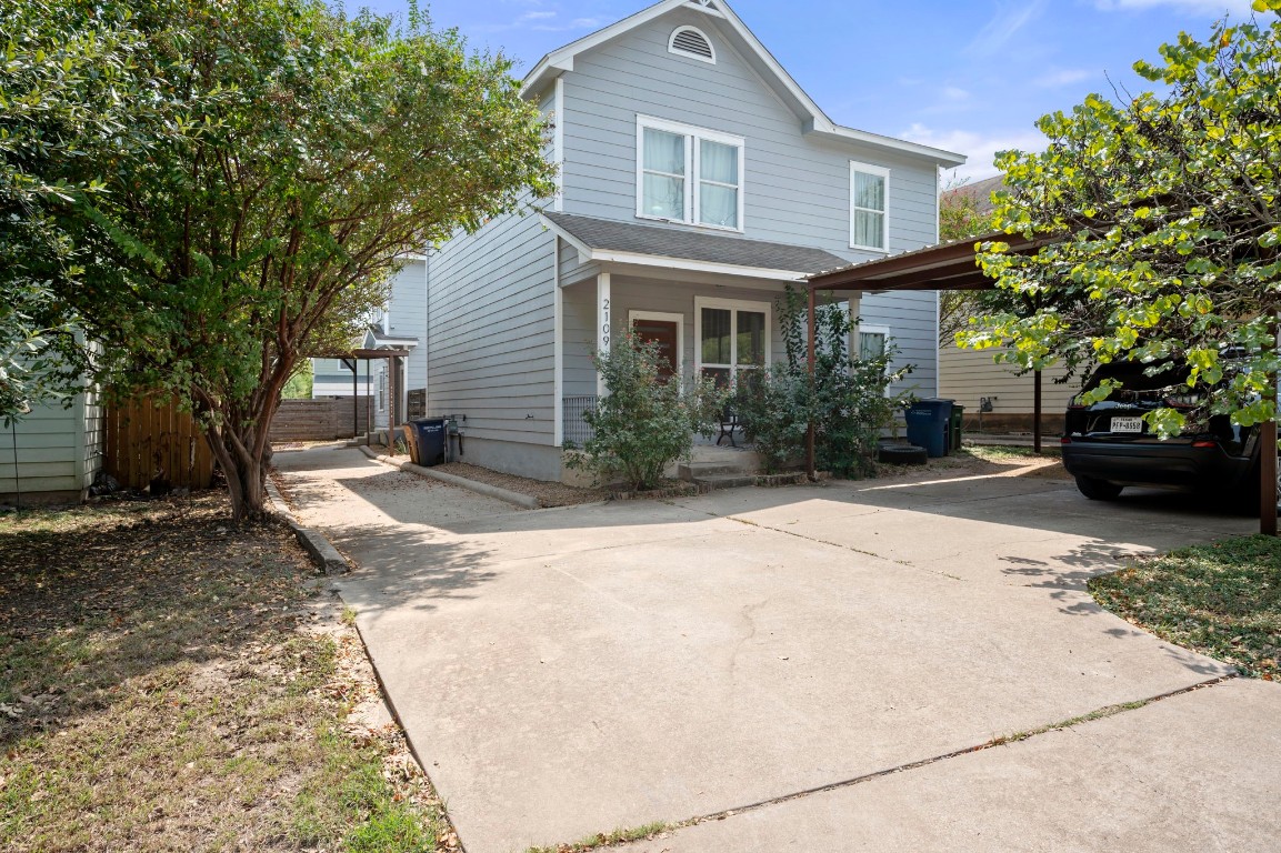 a front view of a house with a yard and a garden