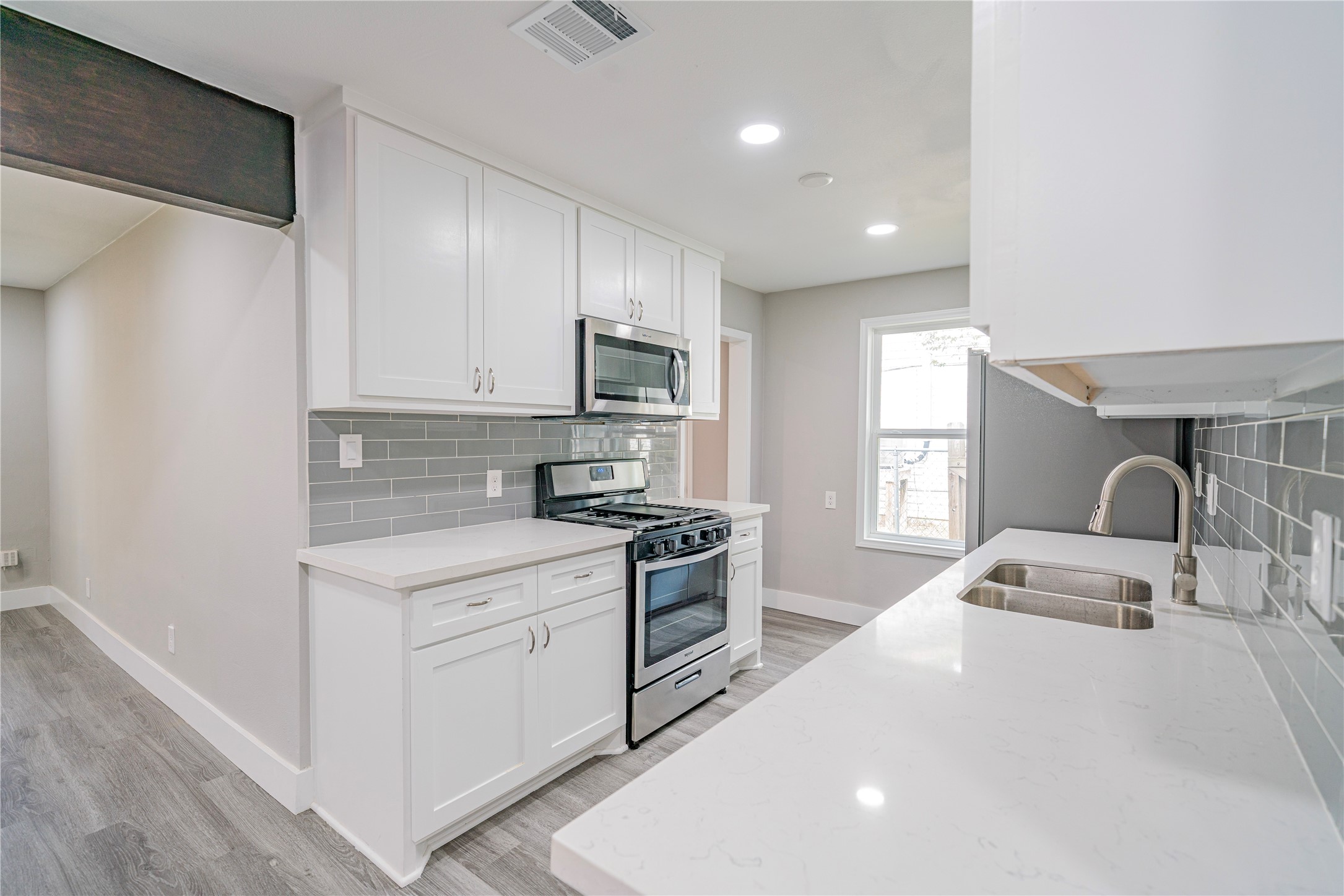 a kitchen with a stove a sink and a refrigerator
