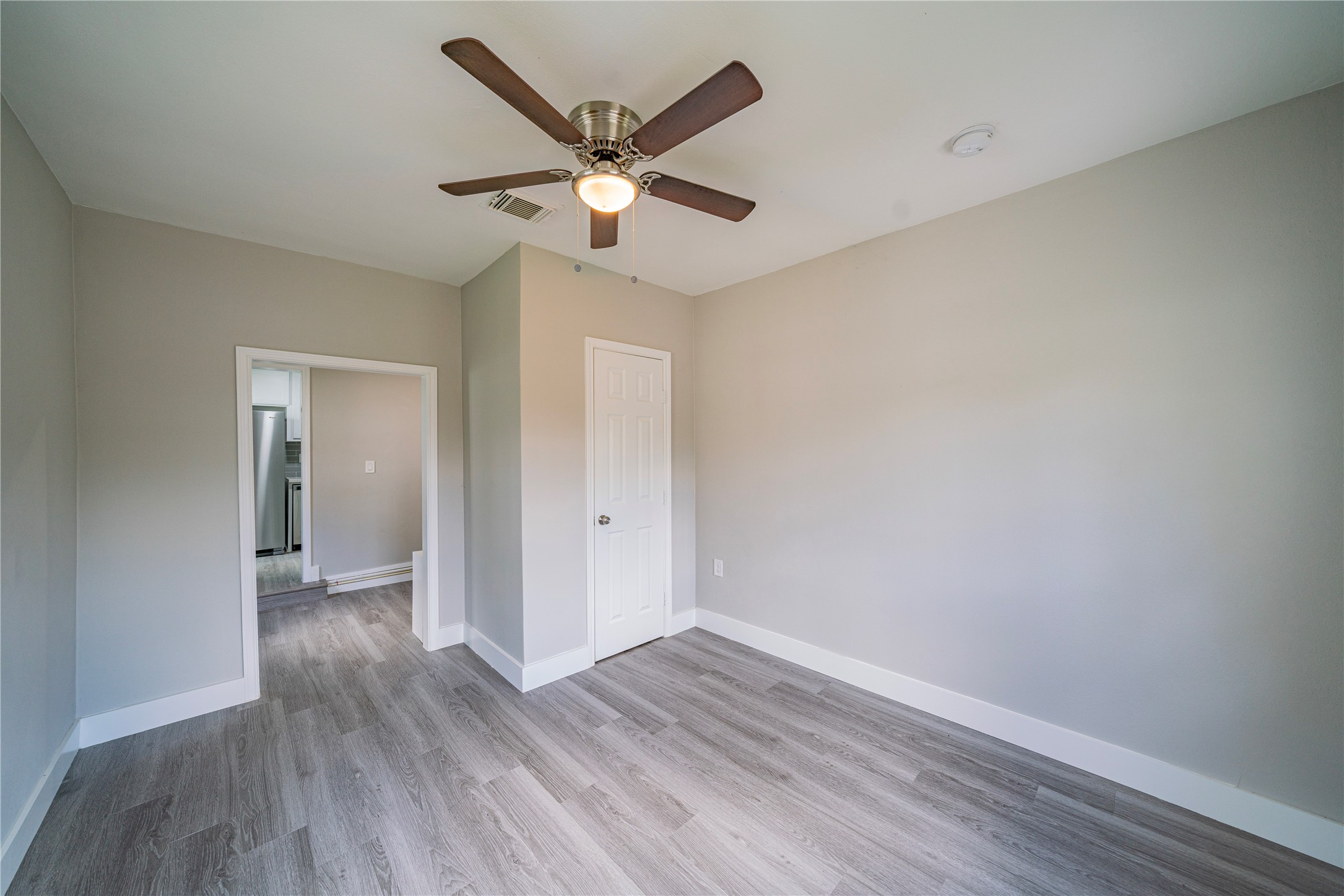 5718 Cherry Street Houston, TX 77026 - Photo 23 of 35 an empty room with wooden floor and a ceiling fan