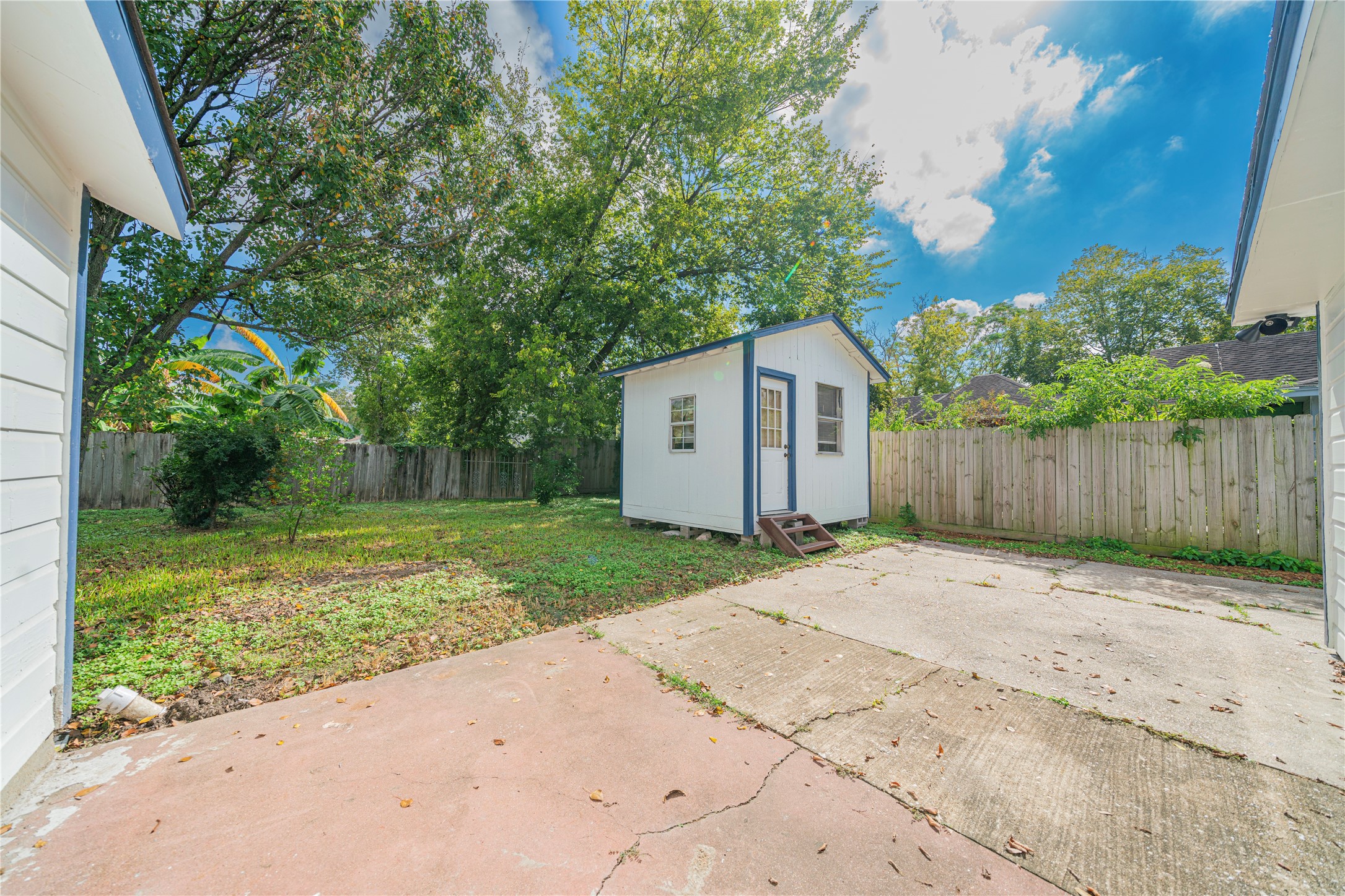 5718 Cherry Street Houston, TX 77026 - Photo 31 of 35 a backyard of a house with large trees and wooden fence