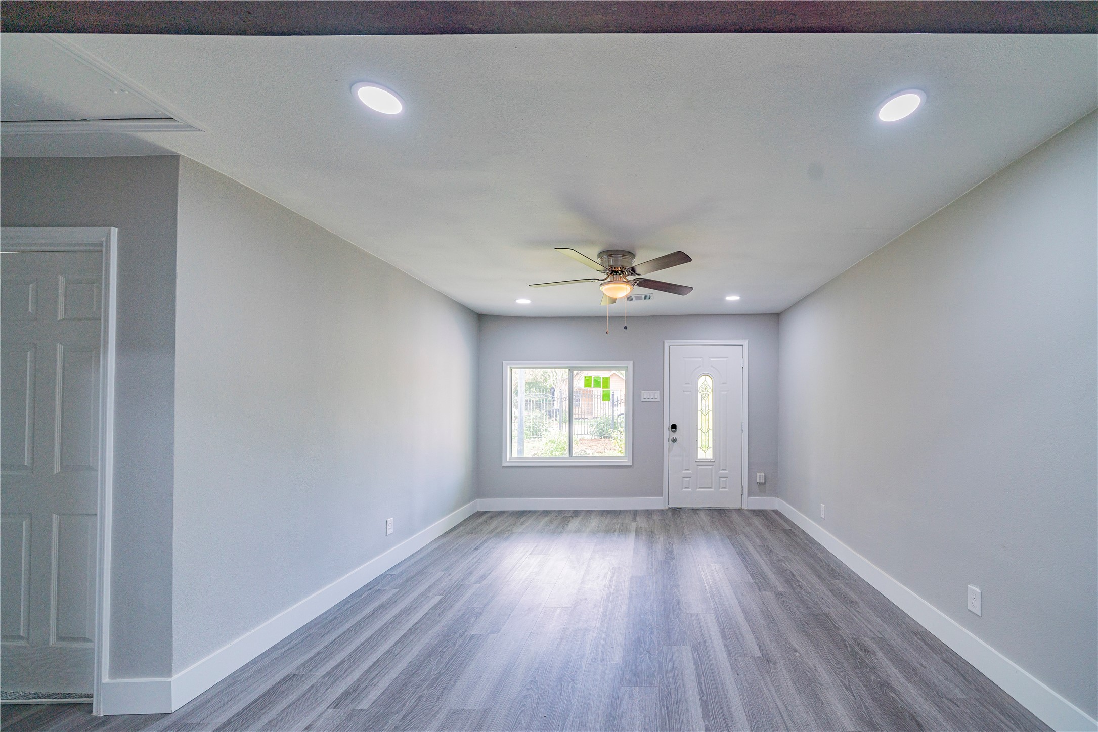 5718 Cherry Street Houston, TX 77026 - Photo 8 of 35 wooden floor in an empty room with a window