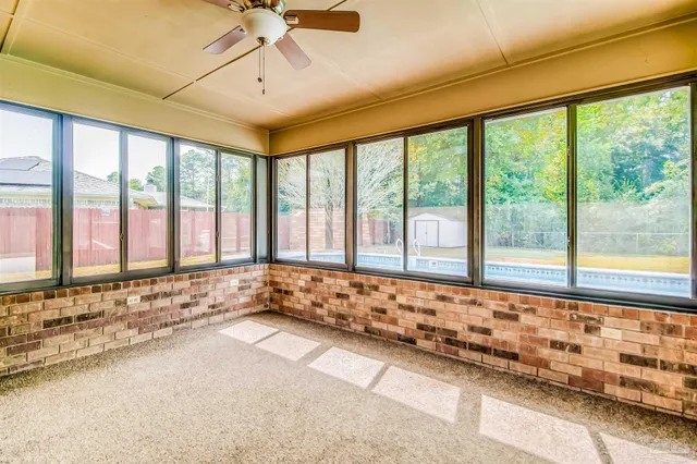 a large white kitchen with a large window