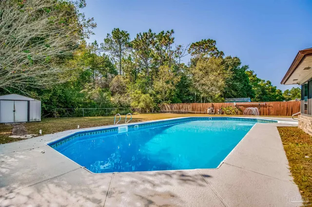 a view of swimming pool with a yard