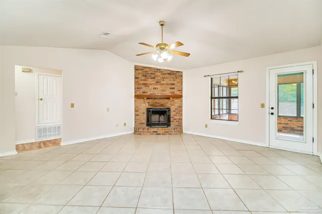 an empty room with fan and windows