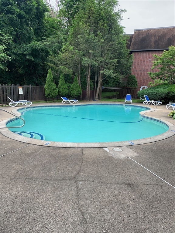 144 Kenrick Street, Unit 37 Boston, MA 02135 - Photo 12 of 12 a view of backyard with swimming pool
