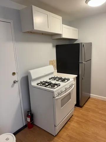 a stove top oven sitting inside of a kitchen