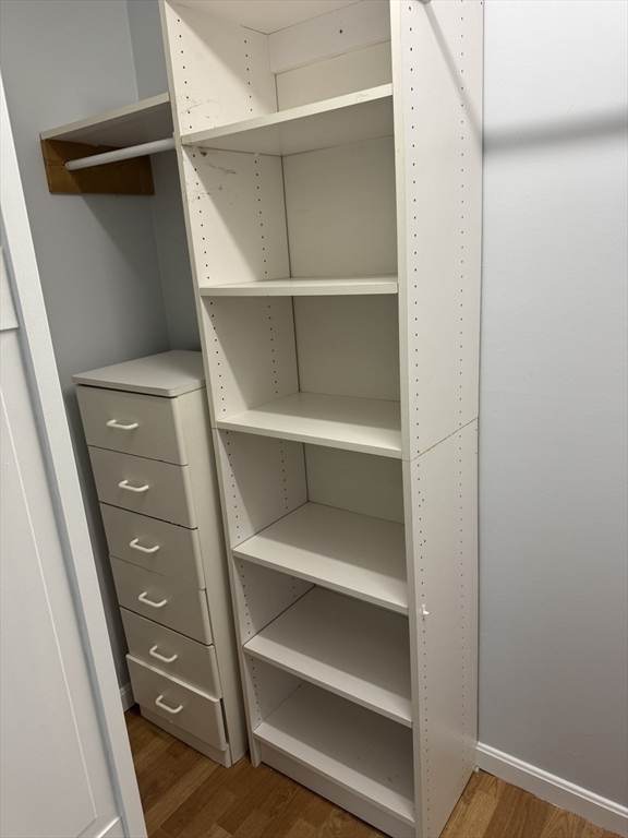 144 Kenrick Street, Unit 37 Boston, MA 02135 - Photo 9 of 12 a view of walk in closet with empty racks