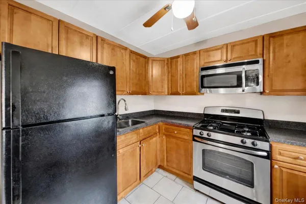 a kitchen with stainless steel appliances a stove a microwave and a sink