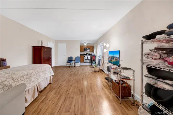 a bedroom with wooden floor and bed