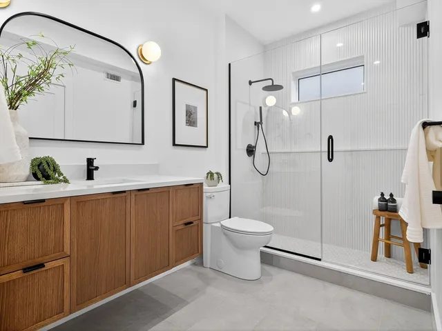 a bathroom with a toilet sink and shower