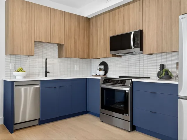 a kitchen with stainless steel appliances a stove a microwave sink and cabinets