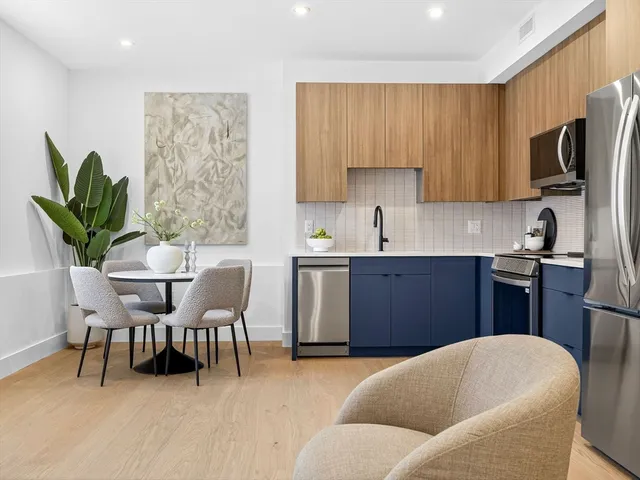 a kitchen with a table chairs sink and microwave