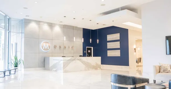 a large white bathroom with a large tub