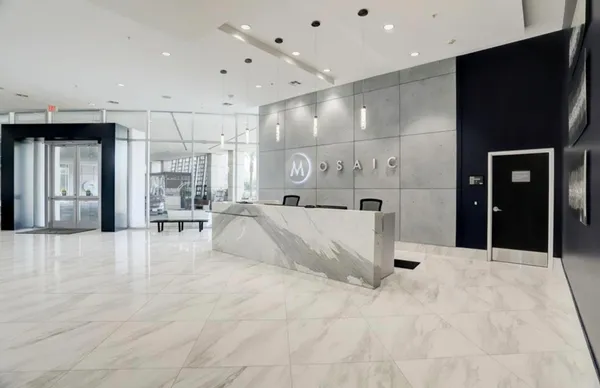 a living room with patio furniture and a large window