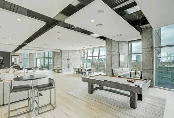 a large kitchen with a table and chairs