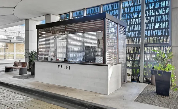 a living room with fireplace furniture and a large window