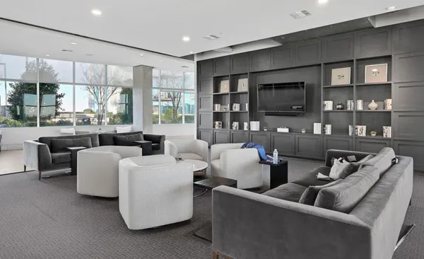 a bathroom with a granite countertop sink a large mirror and shower