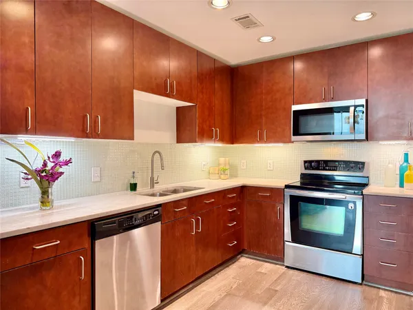 a kitchen with sink cabinets and microwave