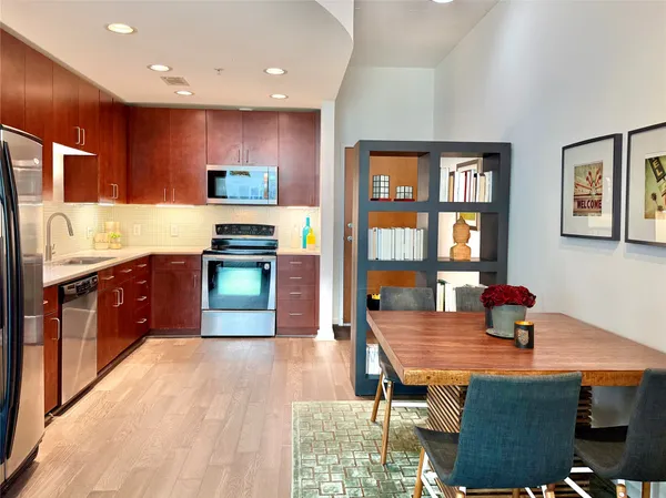 a kitchen with stainless steel appliances granite countertop a stove refrigerator and a sink
