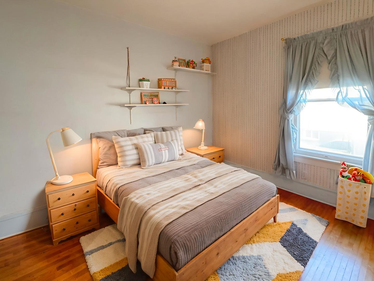 333 Elm Street Elgin, IL 60123 - Photo 16 of 25 a bedroom with a bed and wooden floor