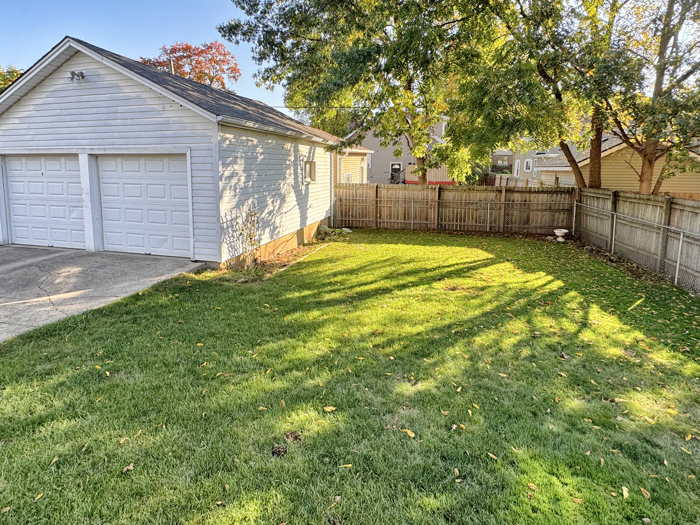 333 Elm Street Elgin, IL 60123 - Photo 25 of 25 a view of backyard with wooden fence and large trees
