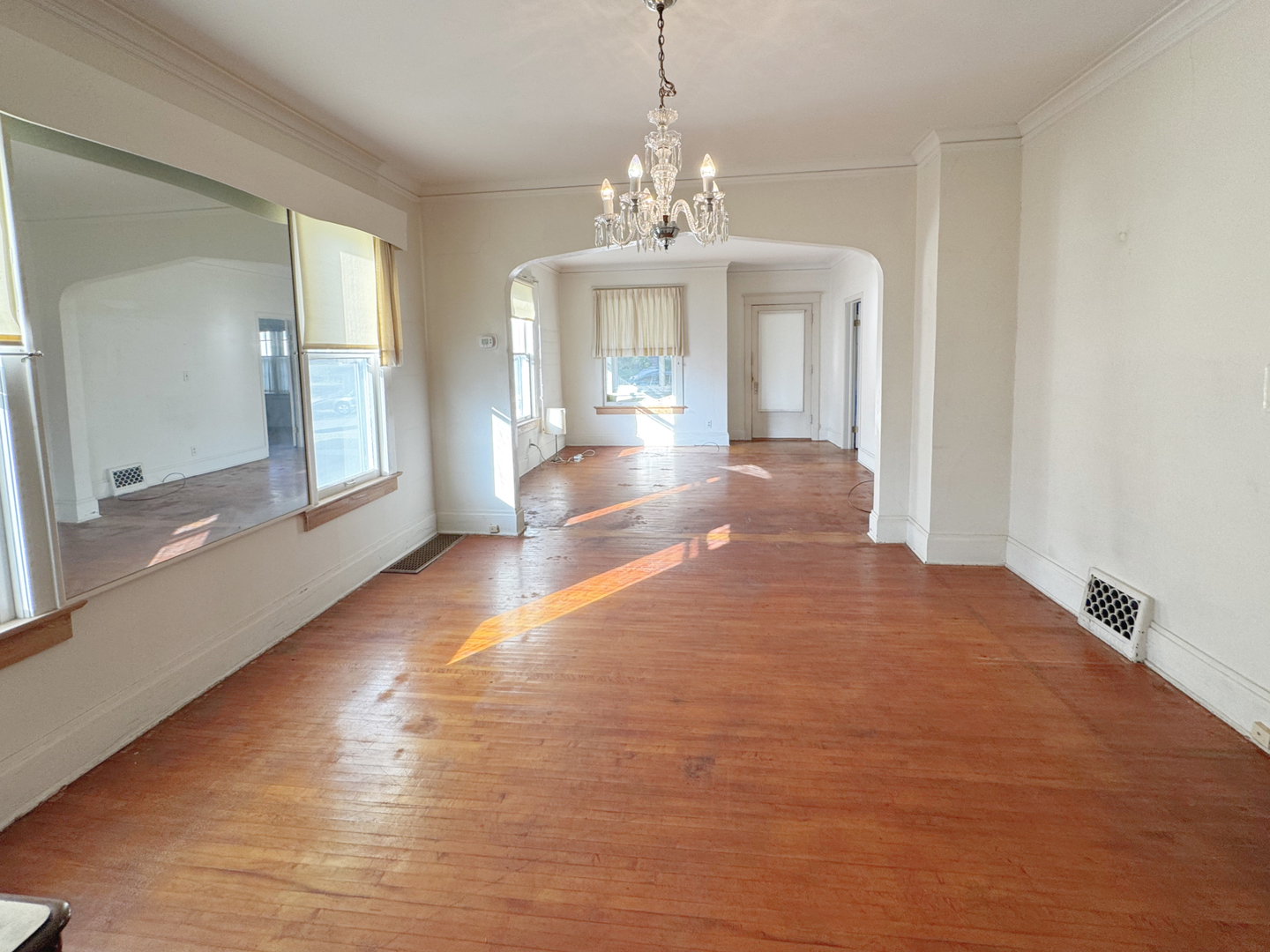 333 Elm Street Elgin, IL 60123 - Photo 8 of 25 a view of an empty room with wooden floor and a chandelier