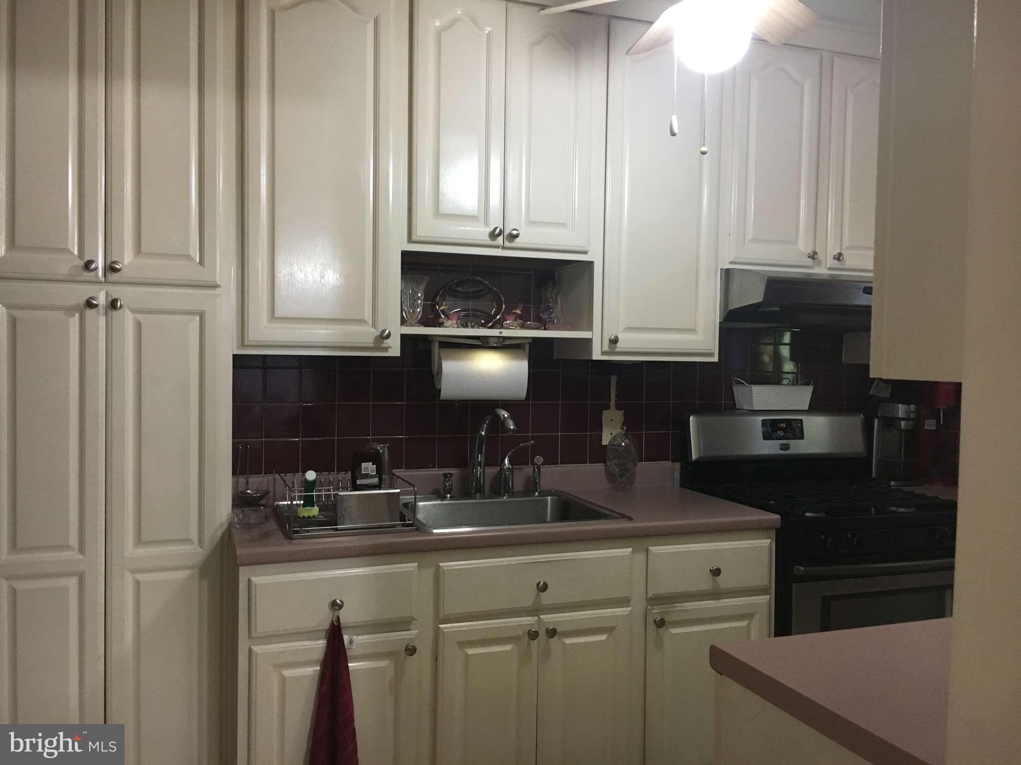 6010 Falkirk Road Baltimore, MD 21239 - Photo 2 of 30 a kitchen with granite countertop white cabinets and black appliances