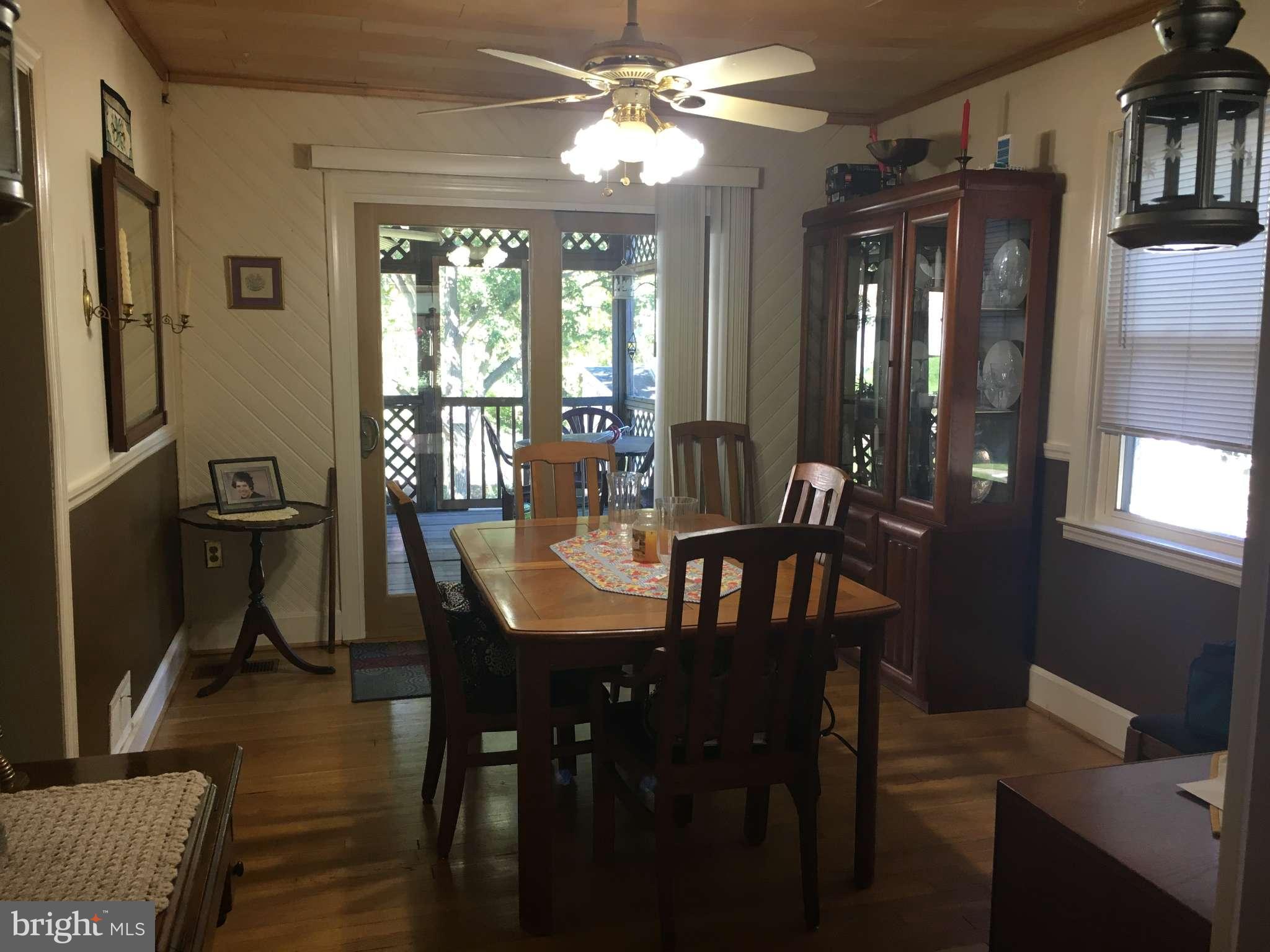 6010 Falkirk Road Baltimore, MD 21239 - Photo 17 of 30 a view of a dining room with furniture window and wooden floor