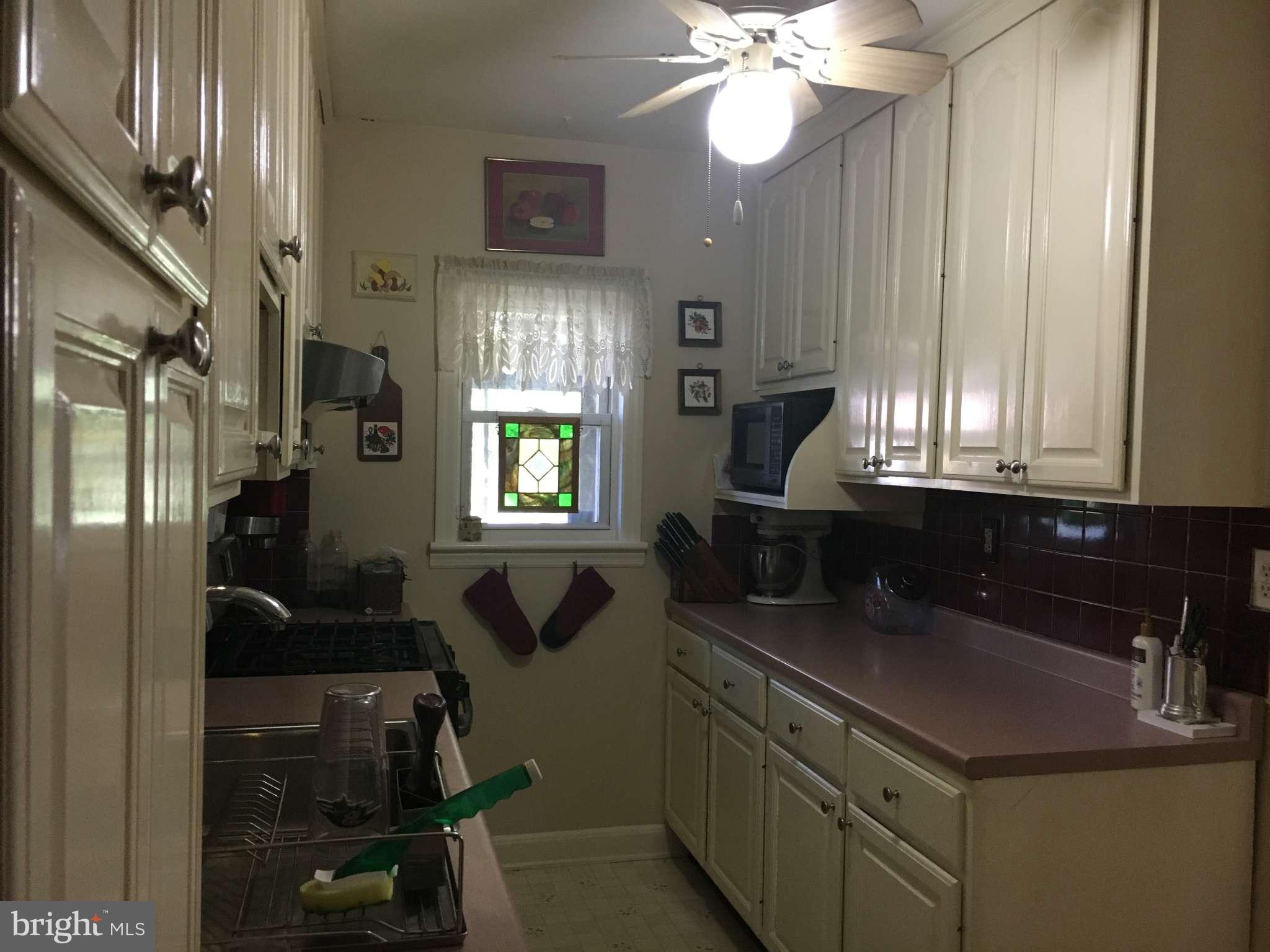6010 Falkirk Road Baltimore, MD 21239 - Photo 3 of 30 a kitchen with a sink cabinets and window