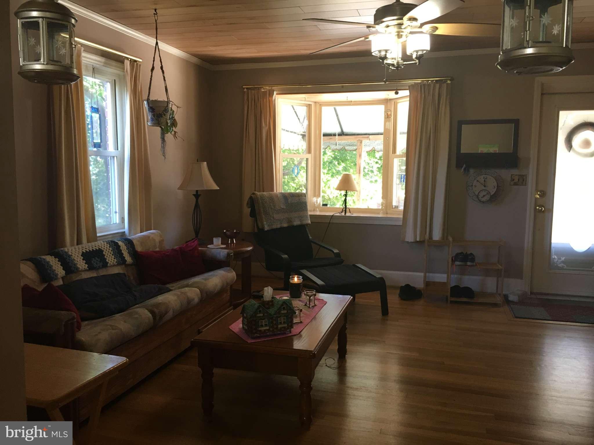 6010 Falkirk Road Baltimore, MD 21239 - Photo 5 of 30 a living room with furniture window and wooden floor